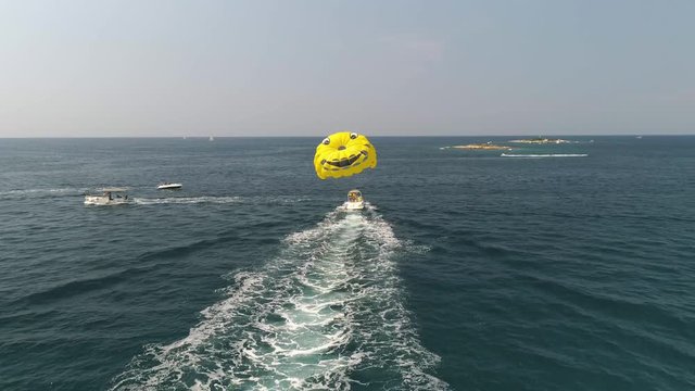 Drone view of parasailing activity in blue Adriatic sea in Istria, Croatia