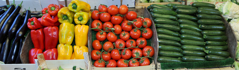 boxes of fresh fruit for sale in the local market with eggplant