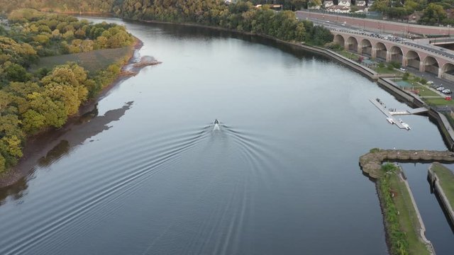 Aerial view of the Raritan River flowing through New Brunswick, New Jersey. Someone on a jestski has fun on the river.