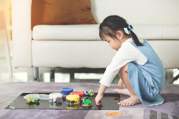 Obraz premium Asian child playing alone in your home