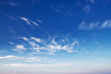 Naklejka na ściany i meble Stunning sunset. Clouds on blue sky. Summertime beatiful sky background.