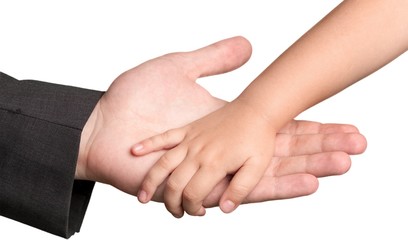Obraz premium Man Giving Hand to a Child