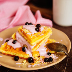 Fresh homemade Viennese waffles, drenched with yogurt and berries