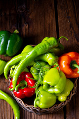 various harvested peppers and hot peppers in basket