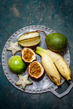 Passion fruit, bananas, carom on a plate