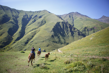 Fototapeta na wymiar Horses and people on mountain roads of Georgia