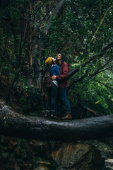 Couple in love getting wet in rain at forest