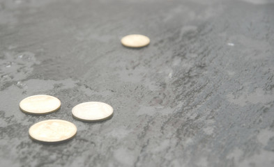Fototapeta na wymiar Coins on a black wet surface.