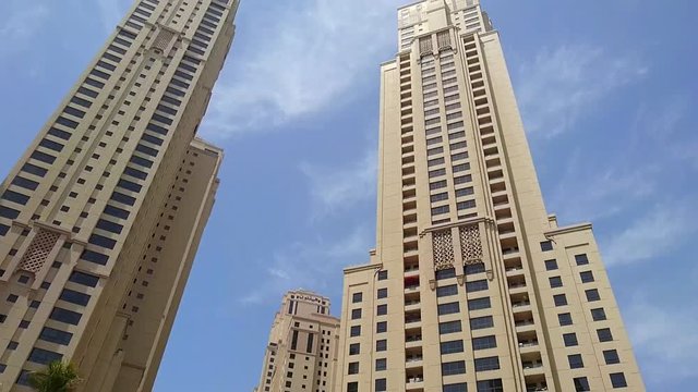 Pan Tilt Day view from street to the blue sky at Apartment/Office Buildings/Towers in Dubai Marina District UAE