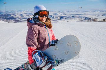 beautiful snowboarder in Orange glasses with snowboarding