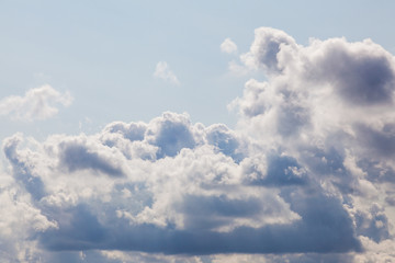 Cumulonimbus clouds in blue sky illuminated on the right