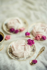 Homemade marshmallow in the shape of a rose on a textile background