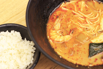Asian spicy soup top view, wooden background, close-up