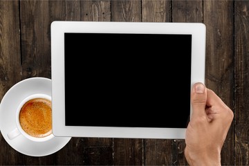 Man and tablet pc   with coffee on  background