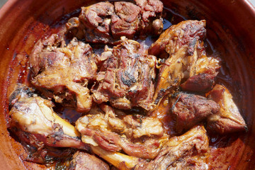 Appetizing roasted lamb in a  pan close-up.Sunny lighting.