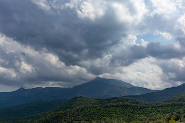 Obraz na płótnie Canvas Storm cloudscape on a green mountain landscape