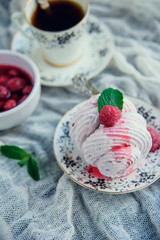 Homemade marshmallow with mint and raspberry, on a light background with textiles.