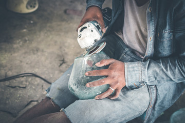 Close-up of a male mechanic with glass polish machine.