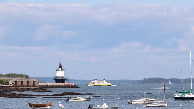Looking out at sail boats anchored in a harbor at Willard Beach in Portland, Maine.