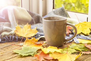 Naklejka na ściany i meble still life a cup of coffee and autumn leaves with plaid