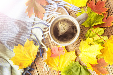 still life a cup of coffee and autumn leaves with plaid