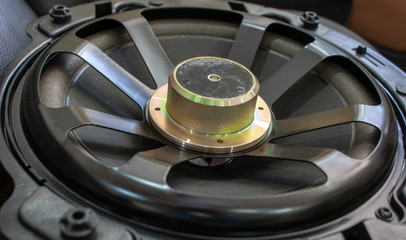 Fototapeta na wymiar Close up shot of a round speaker in a car.