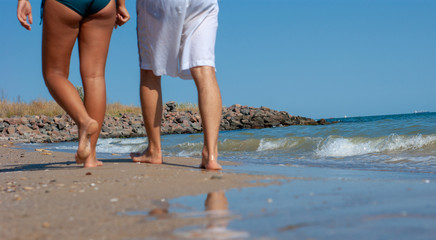 guy with a girl walking along the beach