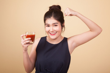 Asian woman with tomato juice and measuring tape.