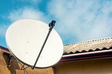 Satellite dish on the wall of a country house
