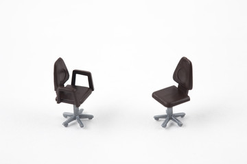two miniature chairs on white background