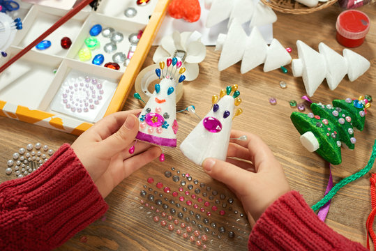 Childrens making decorations for new year holiday. Painting watercolors. Top view. Artwork workplace with creative accessories.