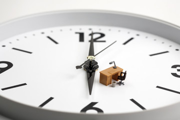 Miniature table and chair on clock background