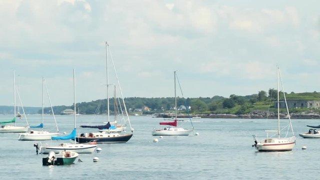 Looking out at sail boats anchored in a harbor at Willard Beach Maine.