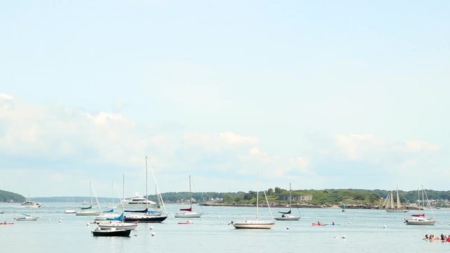 Looking out at sail boats anchored in a harbor at Willard Beach in Portland, Maine.