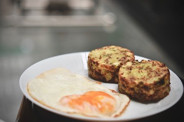 Broccoli savory cake served with fried egg, healthy breakfast. broccoli cheese bites (muffins), double egg yolks