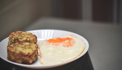 Broccoli savory cake served with fried egg, healthy breakfast. broccoli cheese bites (muffins), double egg yolks