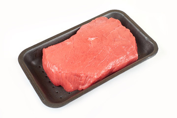 Big red meat chunk in package, on white background
