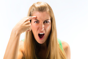 Portrait of an angry young woman shouting against white background
