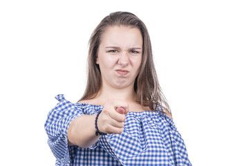 Evil woman in a plaid blouse shows fig isolated on a white background