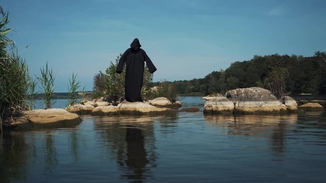 Terrible witch on the river bank. Mysticism of Halloween