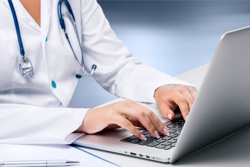 Close-up Doctor at hospital working with laptop
