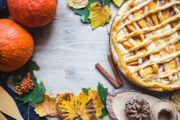 Autumn concept. Pie with Peaches Pumpkin Autumn Foliage Tea Honey On a wooden background