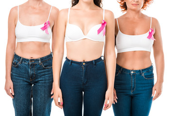 cropped shot of women in bras with breast cancer awareness ribbons standing together isolated on white