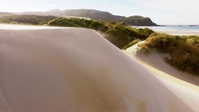 Sand blowing off a dune at Sandfly Bay on Otago peninsula near Dunedin, New Zealand