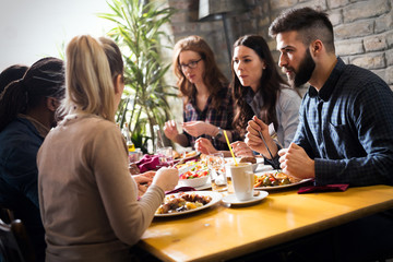 Happy young friends hangout in coffee shop