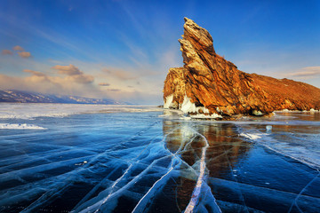 Lake Baikal in winter. Beautiful rocky island Ogoi on a sunny day. Cape Dragon - a natural landmark and a place of tourist excursions