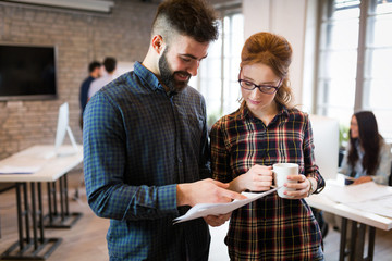 Portrait of young architects discussing in office