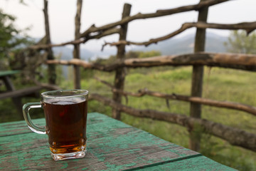 A glass of tea on the green background for weekend or relax concept.