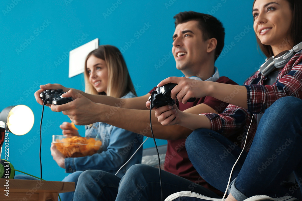 Wall mural young people playing video games at home