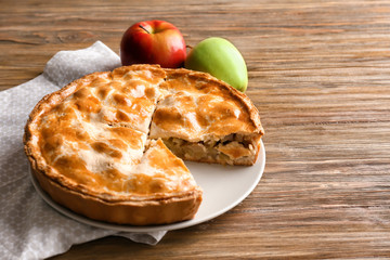 Tasty homemade apple pie on wooden table